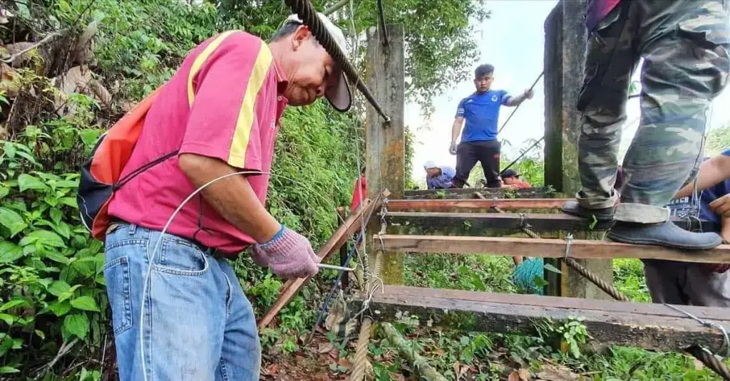 Villagers of Kampung Kaung Ulu cleaning up the surrounding area of the suspension bridge