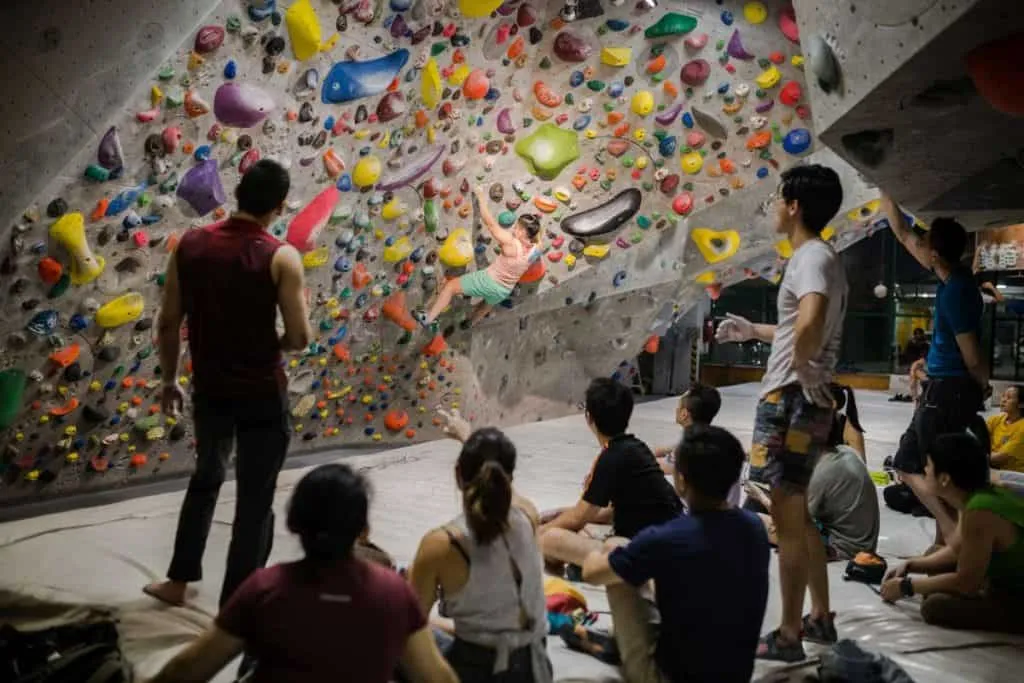 A group of climbers waiting each their turn to scale the wall at Camp5 Climbing Gym