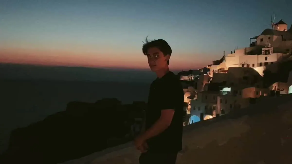 Johnny Orlando standing at the edge of an island posing for a photo shoot