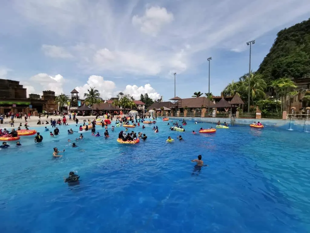 A pool at the Lost World of Tambun filled with many visitors