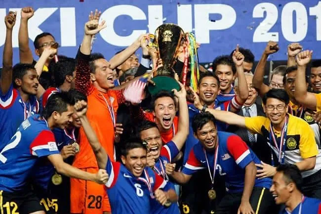 The malaysian national team celebrating their victory