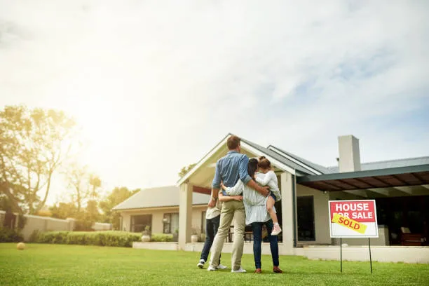 Shot of a family of four viewing their new home together - AI Photo