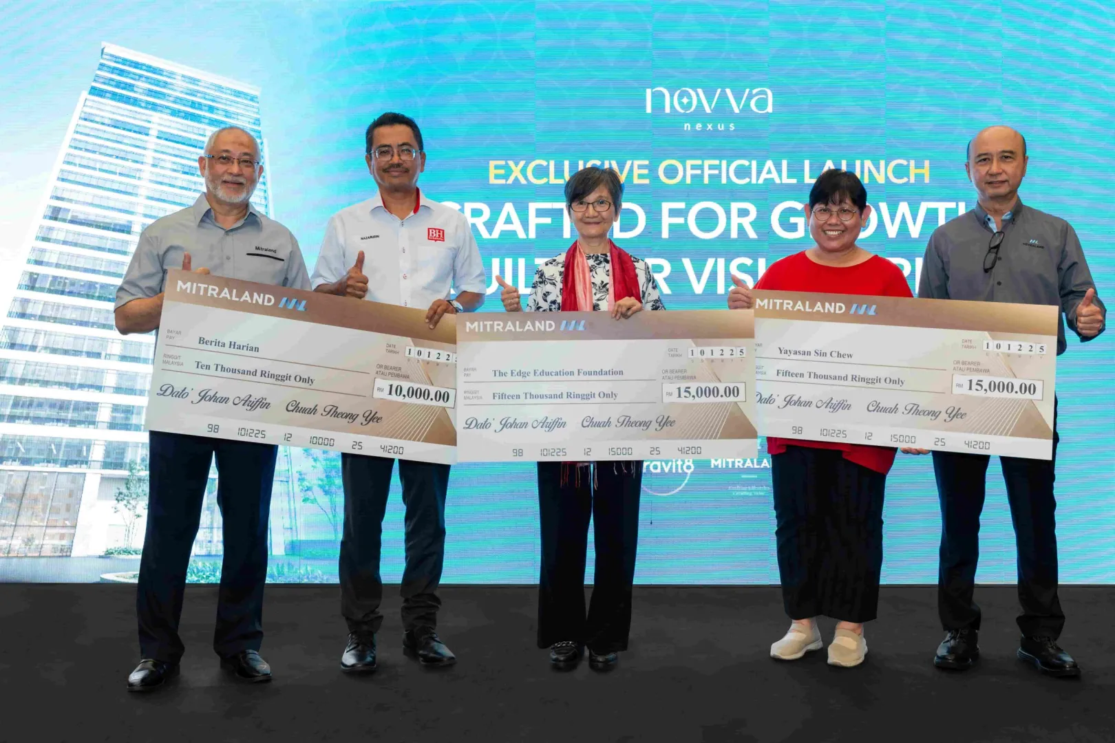 Mitraland Group presents mock cheques to the beneficiary organisations as part of its CSR initiative.